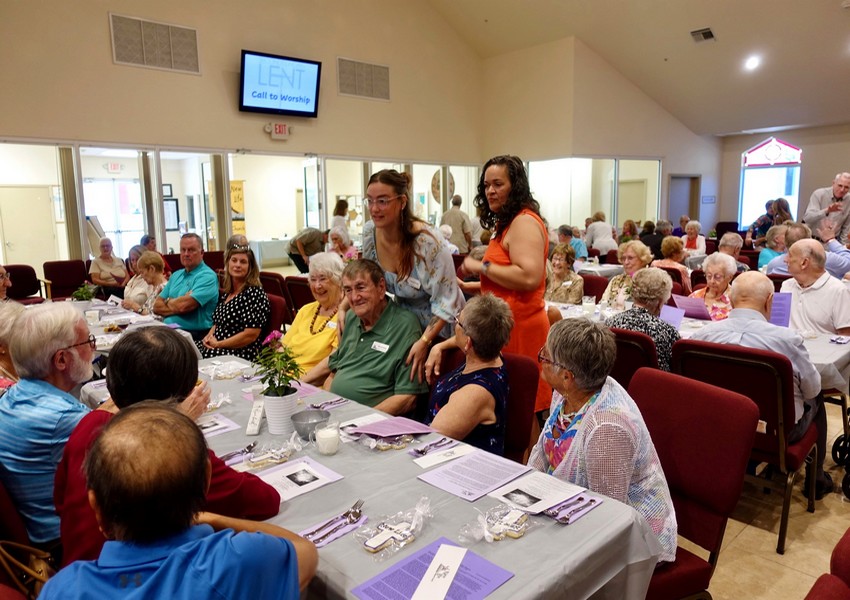Photo of people gather for a Lenten meal